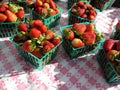 Red Strawberries displayed in baskets on table Royalty Free Stock Photo