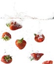 Red Strawberries falling into Water Royalty Free Stock Photo