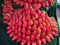 Red strawberries with its green leaves for sale