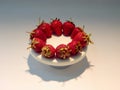 Red strawberries on white round plate studio shot Royalty Free Stock Photo
