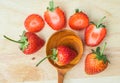 Red strawberries on wood background