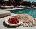 Red Strawberries in Woven Plate by Poolside Royalty Free Stock Photo