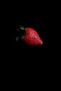 Red strawberry fruit close up skin texture on a black background Royalty Free Stock Photo