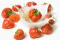 Red strawberry fruits falling into the milk Royalty Free Stock Photo