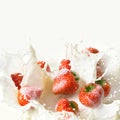 Red strawberry fruits falling into the milk Royalty Free Stock Photo