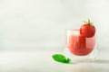 Red strawberry milkshake in glass on grey background with copy space. Summer food concept, vegan diet. Pink smoothie Royalty Free Stock Photo