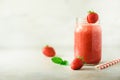 Red strawberry milkshake in glass jar on grey background with copy space. Summer food concept, vegan diet. Pink smoothie Royalty Free Stock Photo
