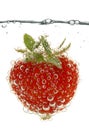 Red strawberry in water with bubbles