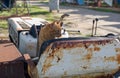 Red stray cat on a rusty abandoned bulldozer