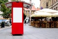Red street vedor kiosk with empty white commercial or ad panel
