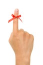 Red string tied around finger as a reminder Royalty Free Stock Photo