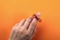 Red String Tied Around a Finger. Memory and Reminder Knot Royalty Free Stock Photo