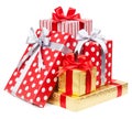 Red and striped and gold boxes with gifts tied bows on white background