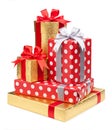 Red and striped and gold boxes with gifts tied bows on white Royalty Free Stock Photo