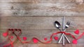 Red strips fork, spoon, knife on wooden table