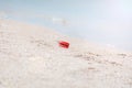 Red buoy lying on the seashell beach of Azov sea