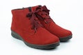 Red suede boots with black soles on a white background. Royalty Free Stock Photo