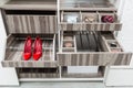 Red suede female shoes on  a shelf, storage for belts and neck ties in a wardrobe Royalty Free Stock Photo