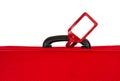 Red suitcase with blank tag over white. Closeup.