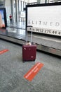 Bodrum, Turkey - August, 2020: Red suitcase near baggage claim line at the airport, Lost luggage. Suitcase in airport Royalty Free Stock Photo