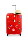 Red suitcase with travel stickers on background Royalty Free Stock Photo