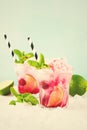 Red Summer cooling drink with ice, lime, raspberries and syrup on light background. Royalty Free Stock Photo