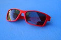 Red Sun Glasses Visual Wear Fashion on Blue Background