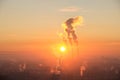 Red sun rise up on the horizon over industrial town. Smoke coming from the thermal power plant pipes. Aerial shot of sunrise Royalty Free Stock Photo