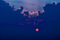 Red sun rising behind the clouds, Nanton, Alberta, canada