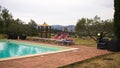 Red sunbeds by the pool in the Italian countryside Tuscany, Italy Royalty Free Stock Photo