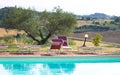 Red sunbeds by the pool in the Italian countryside Tuscany, Italy Royalty Free Stock Photo