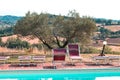 Red sunbeds by the pool in the Italian countryside Tuscany, Italy Royalty Free Stock Photo