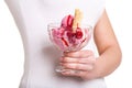 Red sundae in front of torso of woman Royalty Free Stock Photo