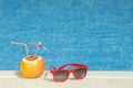 Red sunglasses and Grapefruit with drinking straw and paper parasol Royalty Free Stock Photo