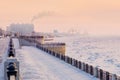 Red sunrise. View of the snow-covered embankment of the Amur River in winter. Early morning.