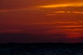 Red sunset across the sky above the sea Royalty Free Stock Photo