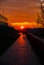 Red sunset in the city with a road and walking couple of people in love Royalty Free Stock Photo