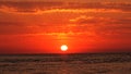 Sunset dark red clouds over sea