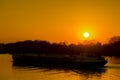 Red sunset over cargo ship on a calm river Royalty Free Stock Photo