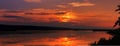 Red Sunset over the lake. overcast colorful clouds in the sky, Royalty Free Stock Photo