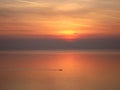 Red sunset over the ocean and little boat Royalty Free Stock Photo