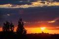 Red sunset over trees with clouds Royalty Free Stock Photo