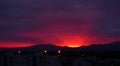 Red Sunset Over the Vosges Mountains: A Panoramic View of Silhouetted Hills, Pink and Purple Sky, with City Lights on the Horizon Royalty Free Stock Photo