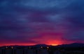 Red Sunset Over the Vosges Mountains: Panoramic View of Silhouetted Hills, Pink and Purple Sky, with City Lights on the Horizon Royalty Free Stock Photo