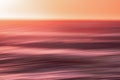 Red sunset. Seascape with blur panning motion. Sunrise or sunset over sea, beautiful soft light red and pink colors Royalty Free Stock Photo