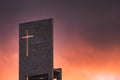 Red sunset on the sky above a modern church with christian cross and copy-space Royalty Free Stock Photo