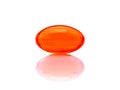 Red supplement capsule isolated on white background