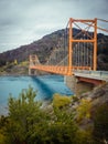 Red suspension bridge over the water runoff of General Carrera Lake, near Lake Bertrand, Puerto Tranquilo, Chile Chico, Aysen, Royalty Free Stock Photo