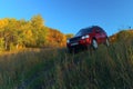 Red SUV LAND ROVER FREELANDER 2 2. Road in the autumn forest Royalty Free Stock Photo