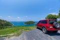 Red SUV 4x4 car on the mountain with Summer sea and blue sky background,Copy space for summer text and travel transportation Royalty Free Stock Photo